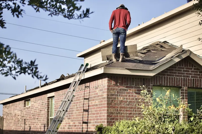 Professional roofer working on a residential roof in Carlsbad